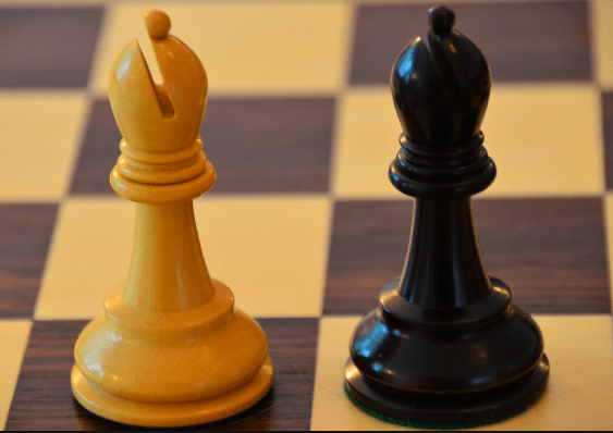 In chess, why are the black and white king / queens opposite each